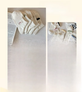 Detail of five pairs of combed cotton dog socks with multi-color salt and pepper knit pattern