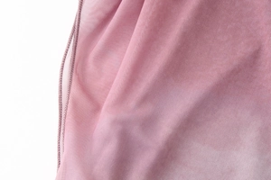 Close-up of soft pink mesh fabric texture showing detailed stitching and woven mesh pattern