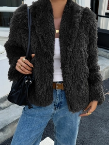 Street style view of women's dark gray plush faux fur coat for the autumn and winter season