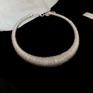 Detailed view of silver chunky choker necklace with industrial tube texture and clasp