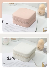 Detail of compact pink and white travel jewelry organizers with zipper closure and texture
