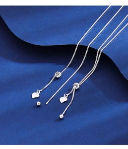 Detail of S925 sterling silver box chain earring with heart pendant and adjustable bead