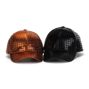 Detail of metallic textured PU leather baseball caps in bronze and black finish