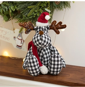 Close-up of black and white plaid reindeer plush with red hat in cozy Christmas setting