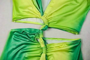 Detailed close-up of the green gradient fabric featuring a central knot and fine stitching