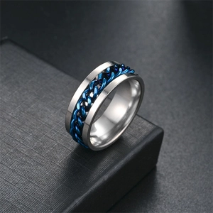 Detail of silver titanium steel ring featuring a rotatable blue chain inlay design