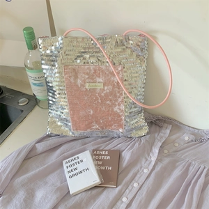 Detail of silver sequin tote bag with pink velvet pocket in a lifestyle setting