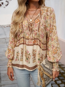 Detail of bohemian floral print long sleeve blouse with beige base and soft fabric
