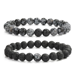 Detailed close-up of 8mm snowflake obsidian and lava stone beaded bracelet set