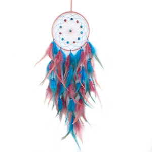 Nordic dream catcher with pink and blue feathers and beads on a clean white background