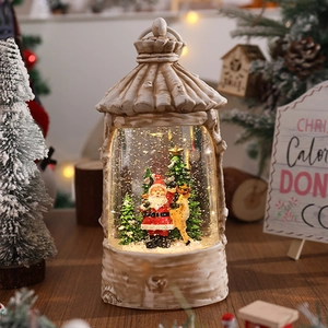 Detail of vintage Christmas lantern music box with Santa, reindeer and glitter snow effect