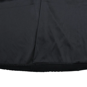 Macro shot of black dress fabric detail with side slit design and fine hem stitching