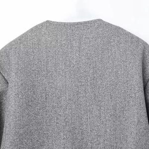 Detail of soft grey fleece bomber jacket showing neck collar and wool texture
