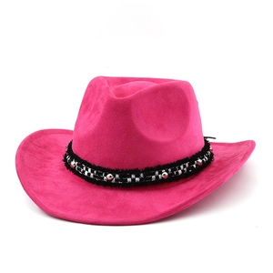 Detail of rose red suede cowboy hat featuring black and white ribbon and silver rivets
