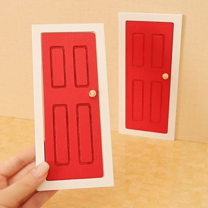 Miniature dollhouse red wooden door set with white frames and tiny door handles