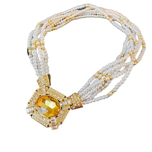 Vintage multi-layer pearl necklace with ornate gold oval yellow gemstone pendant