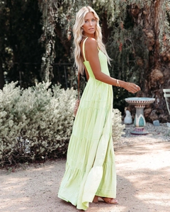 Detail of lime green tiered summer maxi dress with thin straps and boho stripe pattern