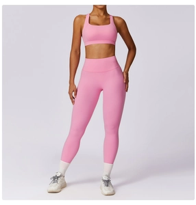 Full view of pink high-waisted yoga leggings and matching sports bra set for women