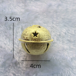 Frosted 4cm gold metal star bell with cutout design on white plush background