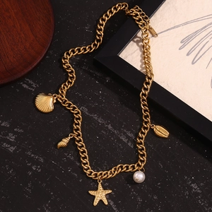 Detailed shot of 18K gold plated necklace with shell, starfish and pearl pendants