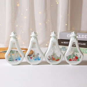 Set of 4 white Christmas LED lanterns with festive reindeer and Santa patterns