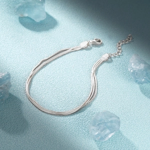 Detail of 925 sterling silver triple snake chain bracelet with adjustable lobster clasp