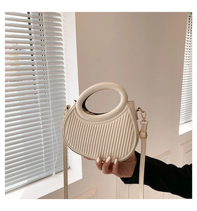 Chic beige crescent moon handbag with pleated texture and stylish circular handle