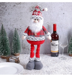 Detail of Santa Claus plush with red plaid jacket and tall hat in a festive holiday setting