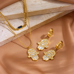 Golden Hamsa Hand layered necklace and earrings set with white shell inlay on stone