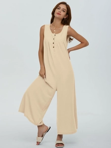Detail of apricot ribbed sleeveless jumpsuit showing front buttons and texture