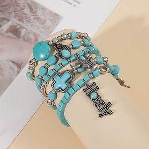 Detail of bohemian turquoise beaded bracelets with a bull skull and HOWDY charm
