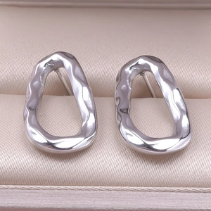 Macro view of 304 stainless steel earrings with irregular lava texture in a jewelry box