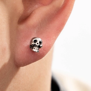 Vintage gothic skull stud earring in oxidized silver finish for a punk rock aesthetic