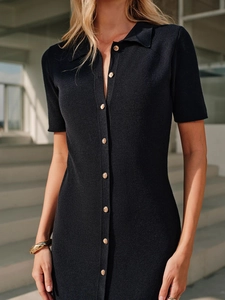 Close-up of a slim-fit knit dress featuring a polo collar and golden buttons