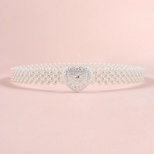 Detailed view of woven white pearl belt featuring a silver heart-shaped vintage buckle