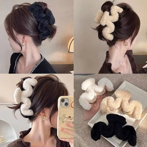 Plush wave claw clip set in black beige and white shown in hair and flat lay
