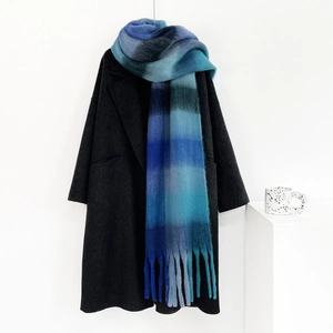 Close-up of blue gradient checkered mohair scarf paired with a grey wool coat