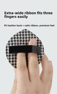 Detail showing wide black satin ribbon on houndstooth puff for three-finger grip