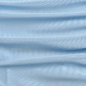 Macro shot of light blue mesh fabric with visible weave texture and soft pleats