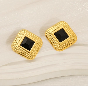 Detail showing vintage square stud earrings with hammered gold frames and black onyx centers