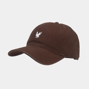 Detailed close-up of white eagle embroidery on high-quality dark brown cotton baseball cap
