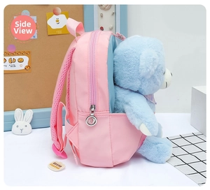 Detailed side view of pink kids backpack showing a blue plush bear inside the pocket