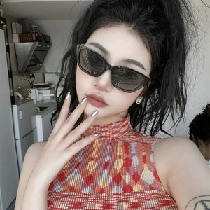 Fashionable narrow cat eye sunglasses with black frames and dark lenses worn by a model