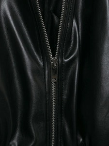 Close-up of premium black leather jacket texture with high-quality silver metal zipper