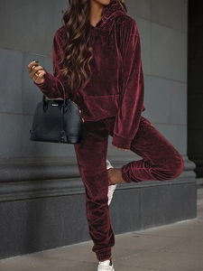 Close-up of wine red velvet hoodie texture and drawstring detail on casual tracksuit