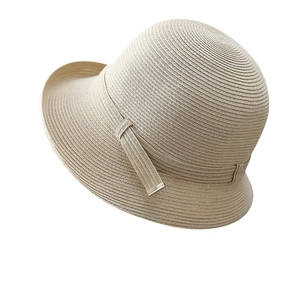 Beige woven straw sun hat with rolled edge and decorative metal buckle strap