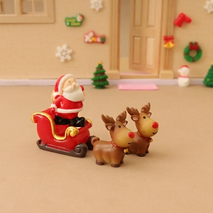 Miniature Santa Claus in red sleigh with two reindeer figurines for Christmas decor