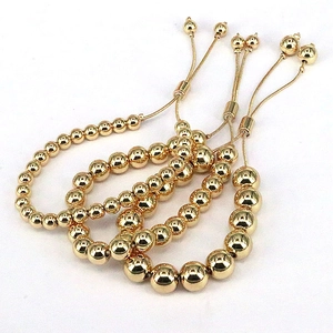Three-piece stackable golden bead bracelets with adjustable toggle clasp in polished metal