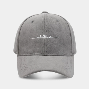 Detail of dark gray baseball cap with white 'whatever' embroidery and suede texture