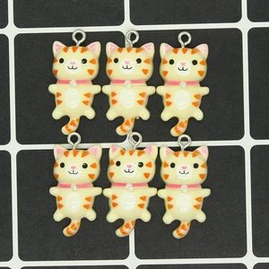 Top view of six cute resin cat charms with orange stripes and metal rings for DIY jewelry